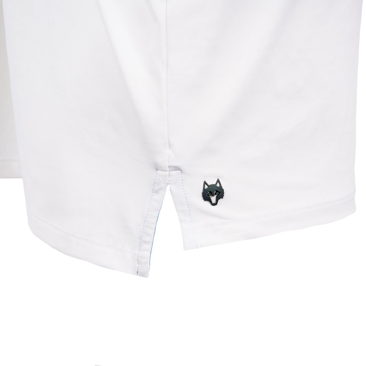 Close up image of the Greyson logo on bottom right hip area on the white polo.