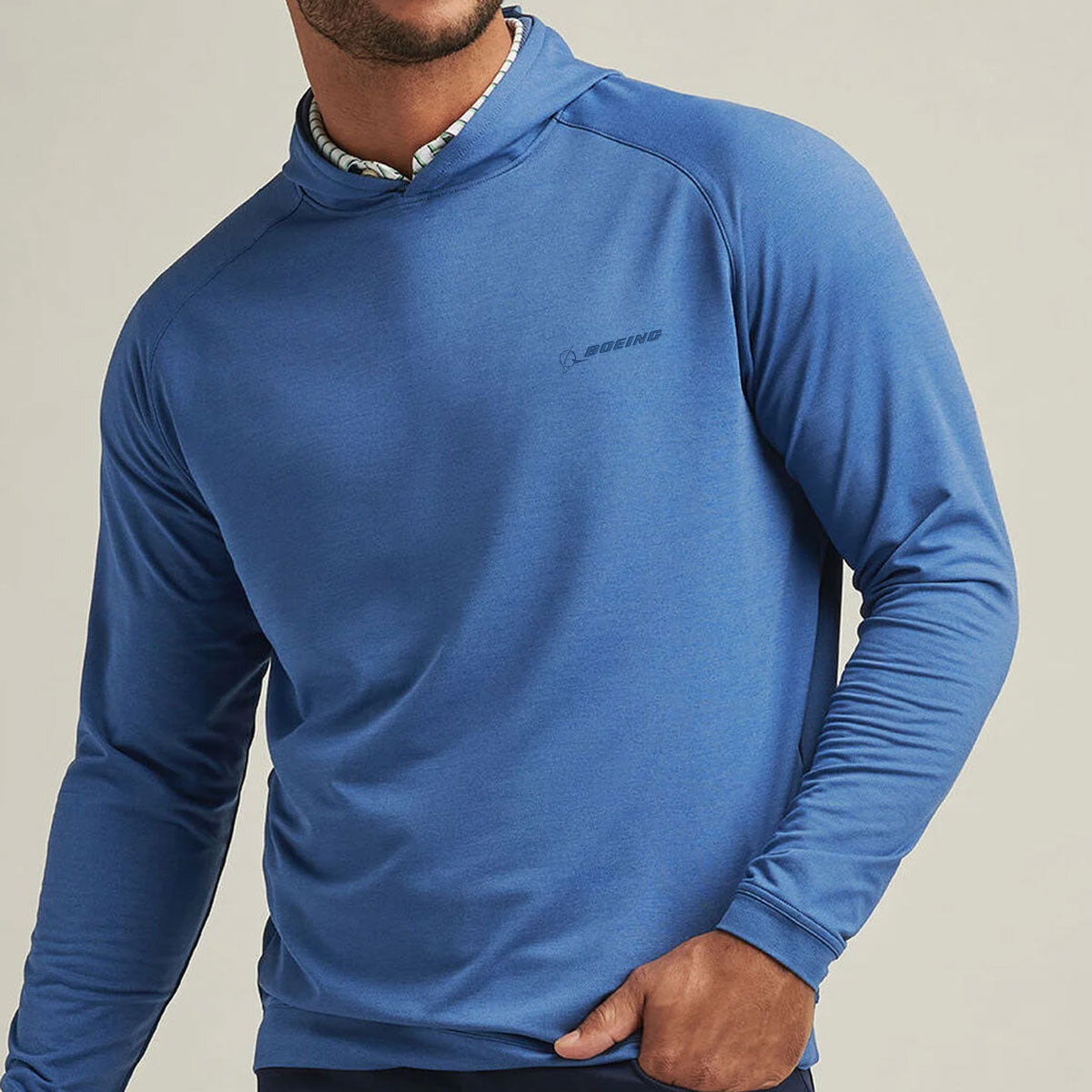 Model wearing the pullover hoodie with polo underneath.  Left arm in left front pocket of the pants