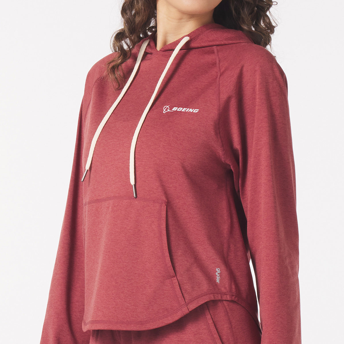 Full product image of the hooded sweatshirt in brick red color.  White Boeing signature logo on left chest.  White hood strings and pouch pocket.  Glyder logo on lower left hip area. 