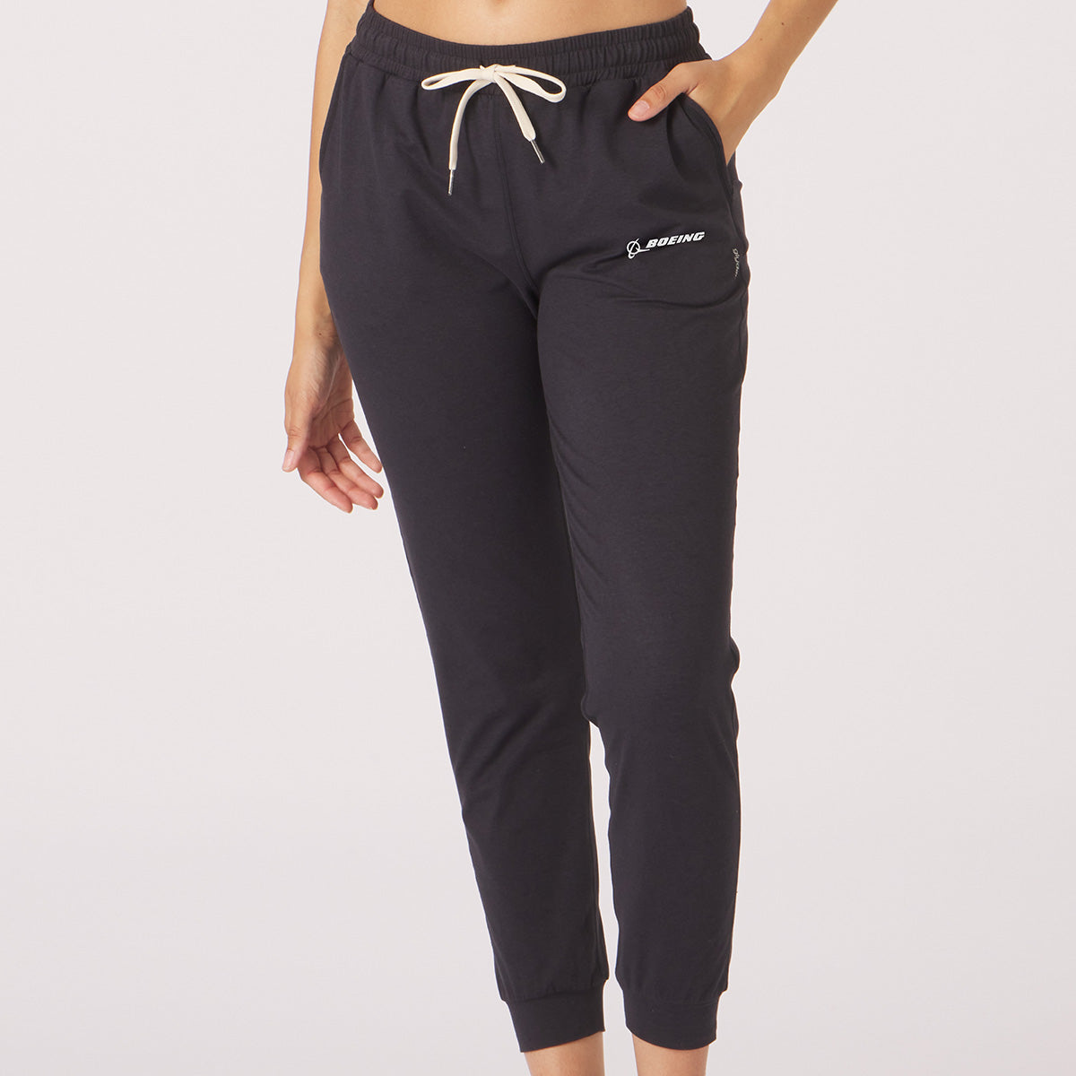 Full product shot of the jogger pants in brick black color.  White Boeing signature logo near left pocket.  Features waist band and white draw strings.