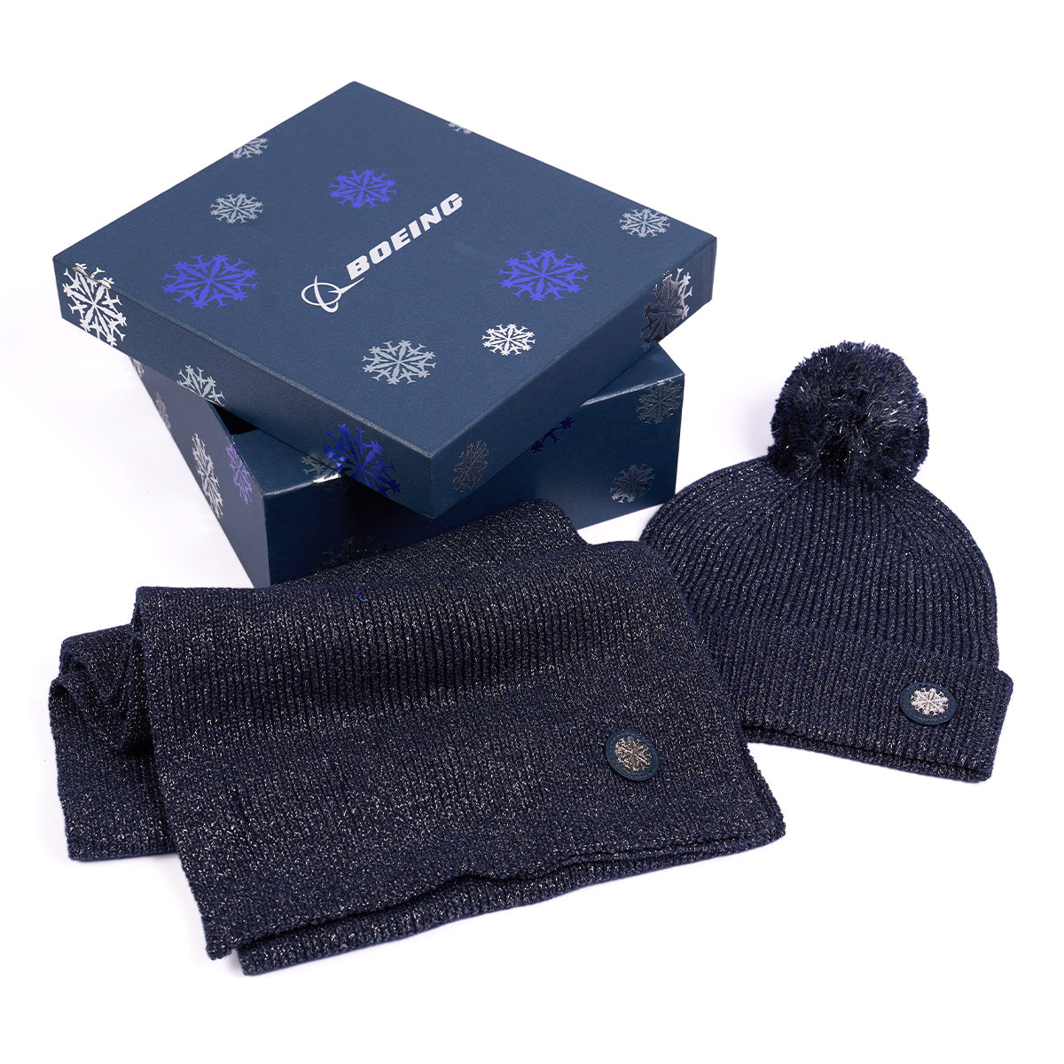 Image of the scarf and beanie shown outside of the gift box that is included.  Bpx is navy with the Jet Snowflake printed all over. 