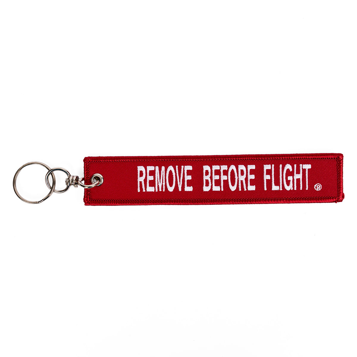 Red "Remove Before Flight" keychain with white lettering. 